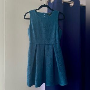 Sleeveless Mini Dress with Box Pleats, Floral Details, and Keyhole Back